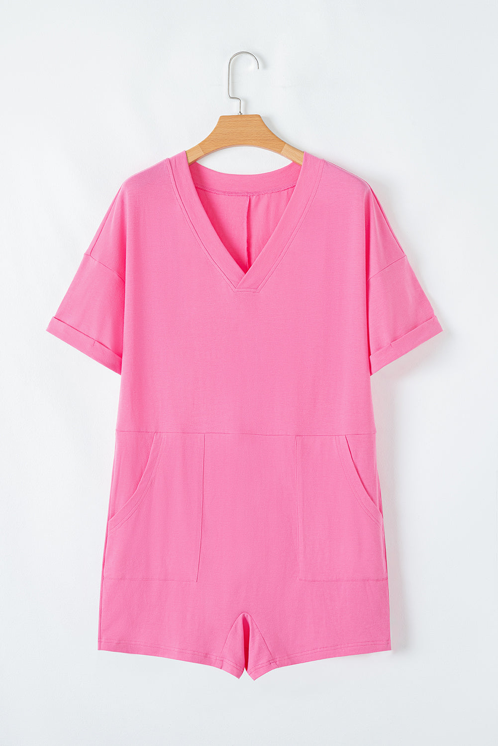 Soft strawberry pink Dream Daze romper with V-neck and short sleeves, perfect for casual, stylish comfort.