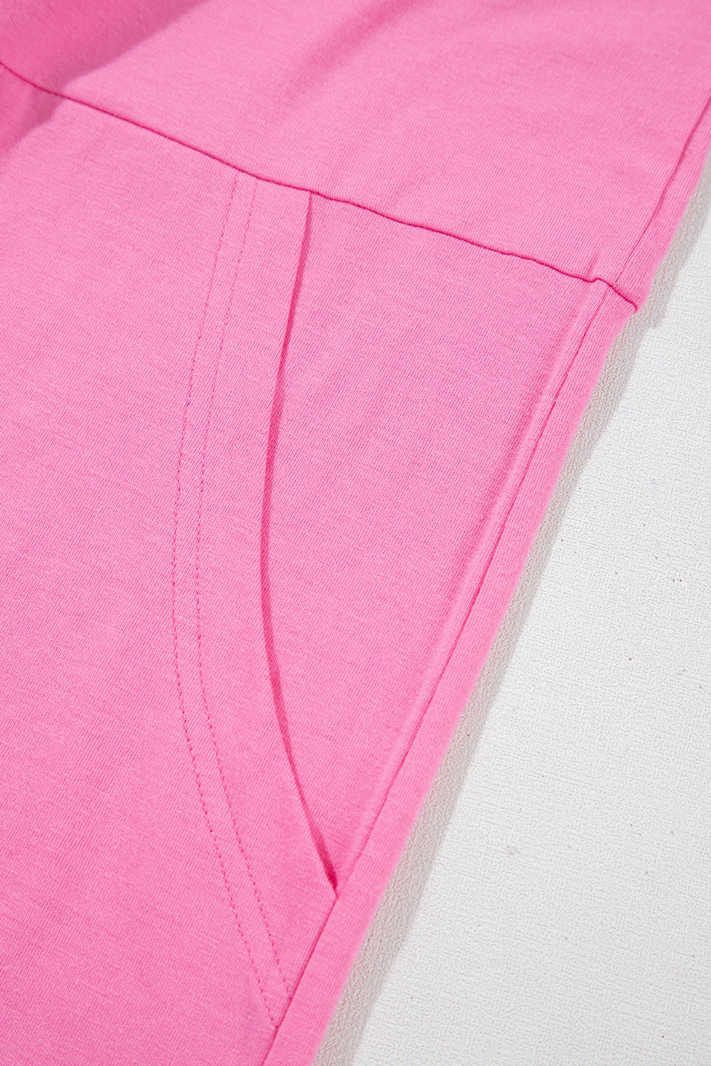 Close-up of the breathable fabric and pocket detail of the Dream Daze Strawberry Pink Romper.