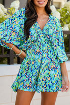 WAVE DANCER ROMPER in green and blue abstract print, featuring puff sleeves and a flattering V-neckline.