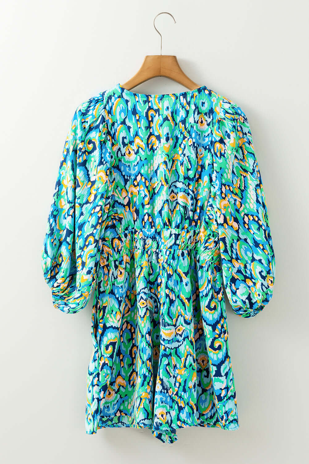Wave Dancer Romper back view with green and blue abstract print, puff sleeves, and flattering fit.