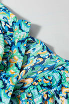 Close-up of the Wave Dancer Romper featuring vibrant green and blue abstract print with puff sleeves.