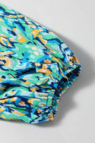 Colorful green and blue abstract print fabric featuring puff sleeve detail from the Wave Dancer Romper.