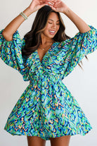 Wave Dancer Romper in green and blue abstract print, featuring a V-neckline and puff sleeves for summer style.