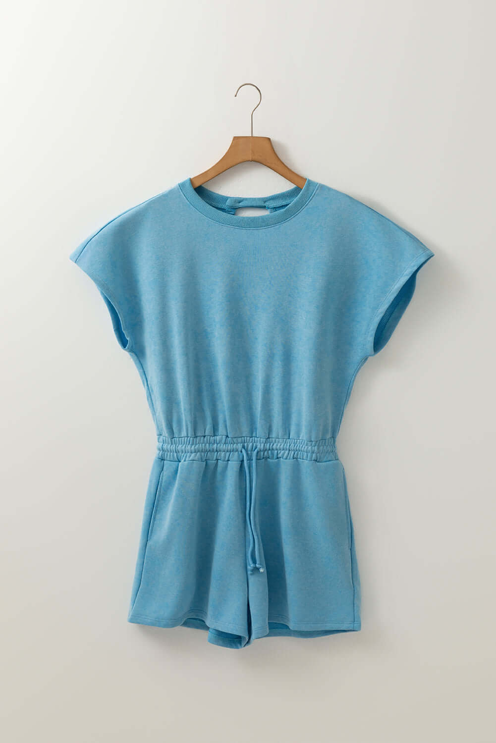 Sky blue Chill Factor Romper with short sleeves and drawstring waist, featuring a mineral wash finish and pockets.