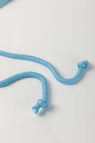 Close-up of a sky blue elastic drawstring cord with knots, perfect for adjusting waistlines.