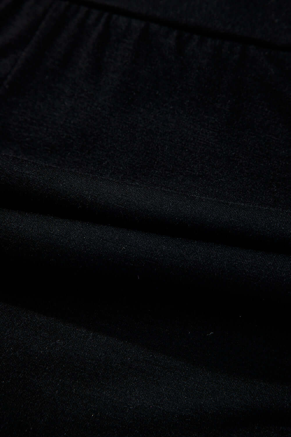 Close-up of black fabric featuring ruching, ideal for the Eclipse Edge Skort's comfortable design.