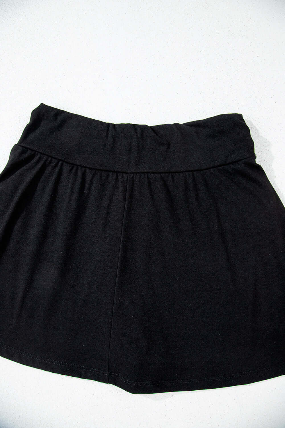 Eclipse Edge Skort in black, featuring a wide waistband and ruched design for stylish comfort.