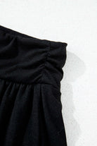 Close-up of the ruched waistband on the black Eclipse Edge Skort, showcasing its sleek design and comfortable fit.