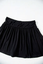 Eclipse Edge Skort featuring a black wide waistband and flattering ruched design, perfect for activewear.