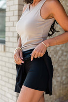 Model showcasing the Eclipse Edge Skort, styled with a beige tank top, highlighting its sleek design and comfort.