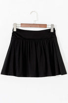 Black Eclipse Edge skort with wide waistband and ruched detail, ideal for activewear and everyday comfort.