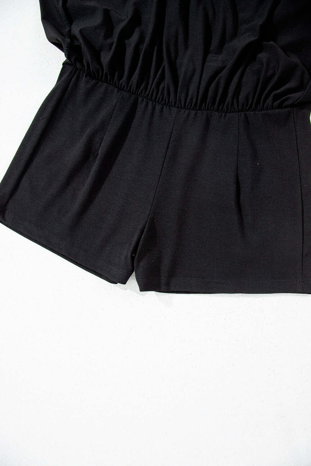 Black skort with wide waistband and built-in shorts for comfort and style.