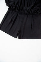 Black skort with wide waistband and built-in shorts for comfort and style.