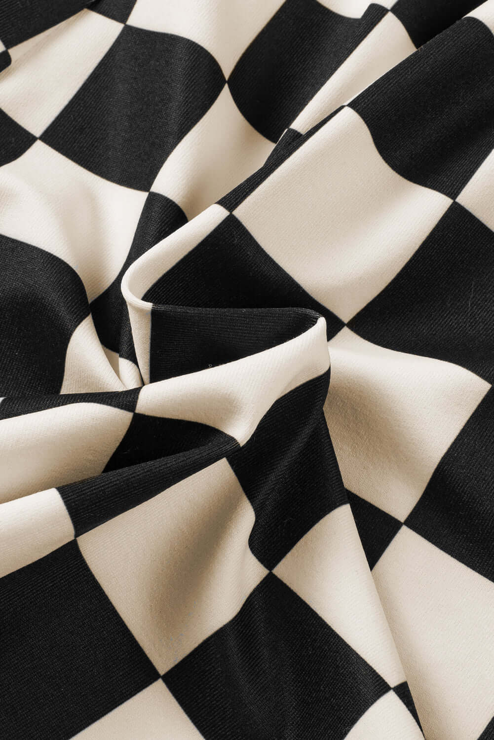 Close-up of black and white checkered fabric, ideal for casual wear like Fast Lane Shorts.