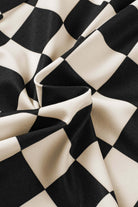 Close-up of black and white checkered fabric, ideal for casual wear like Fast Lane Shorts.