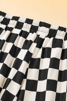 Close-up of black and white checkered drawstring shorts waistband for a stylish and casual look.