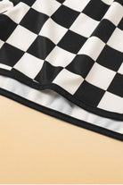 Close-up of black and white checkered fabric, showcasing the design of Fast Lane Shorts.