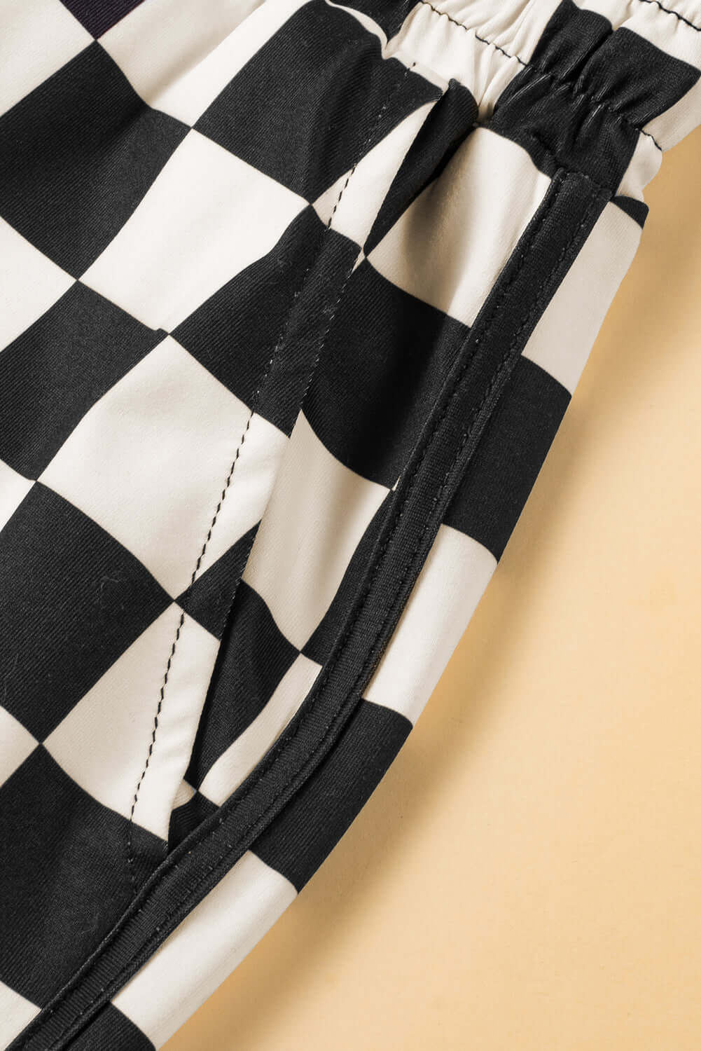 Close-up of the Fast Lane Shorts featuring a classic black and white checkered pattern and drawstring detail.