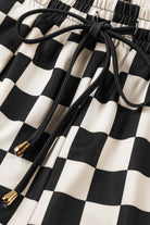 Close-up of Fast Lane Shorts featuring black checkered pattern and drawstring detail for casual style.