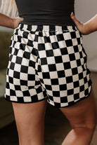 Model showcasing black and white checkered Fast Lane Shorts from the back, emphasizing comfort and style.