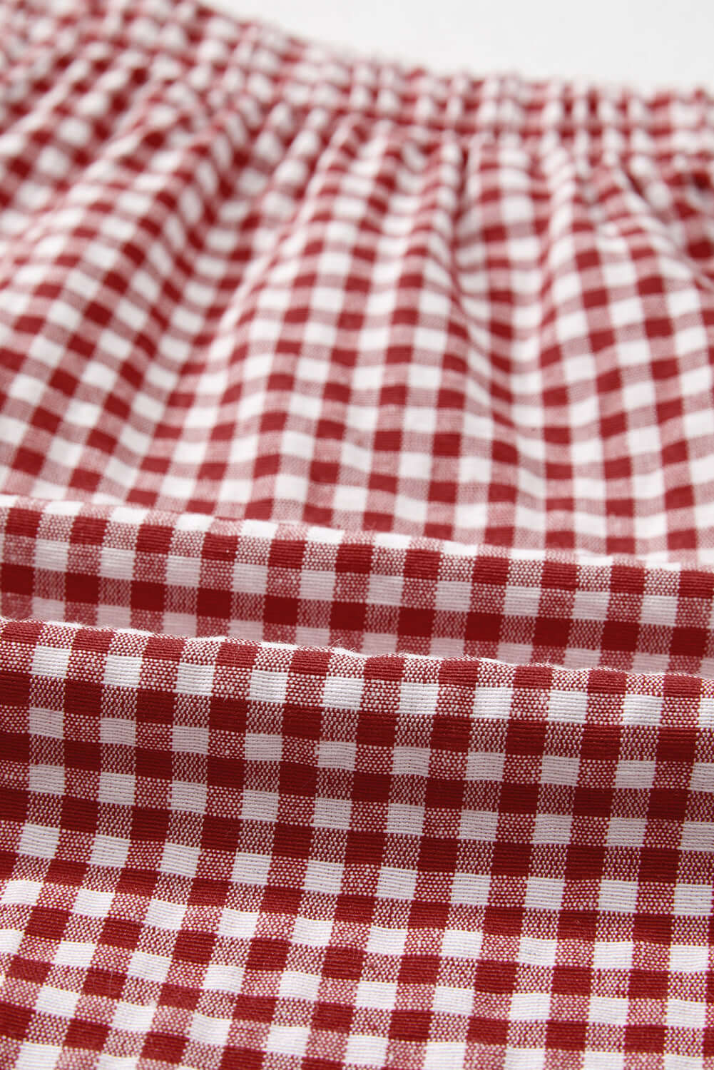 Close-up of red gingham fabric for Picnic Perfect Shorts, showcasing its high waist and comfortable elastic waistband.