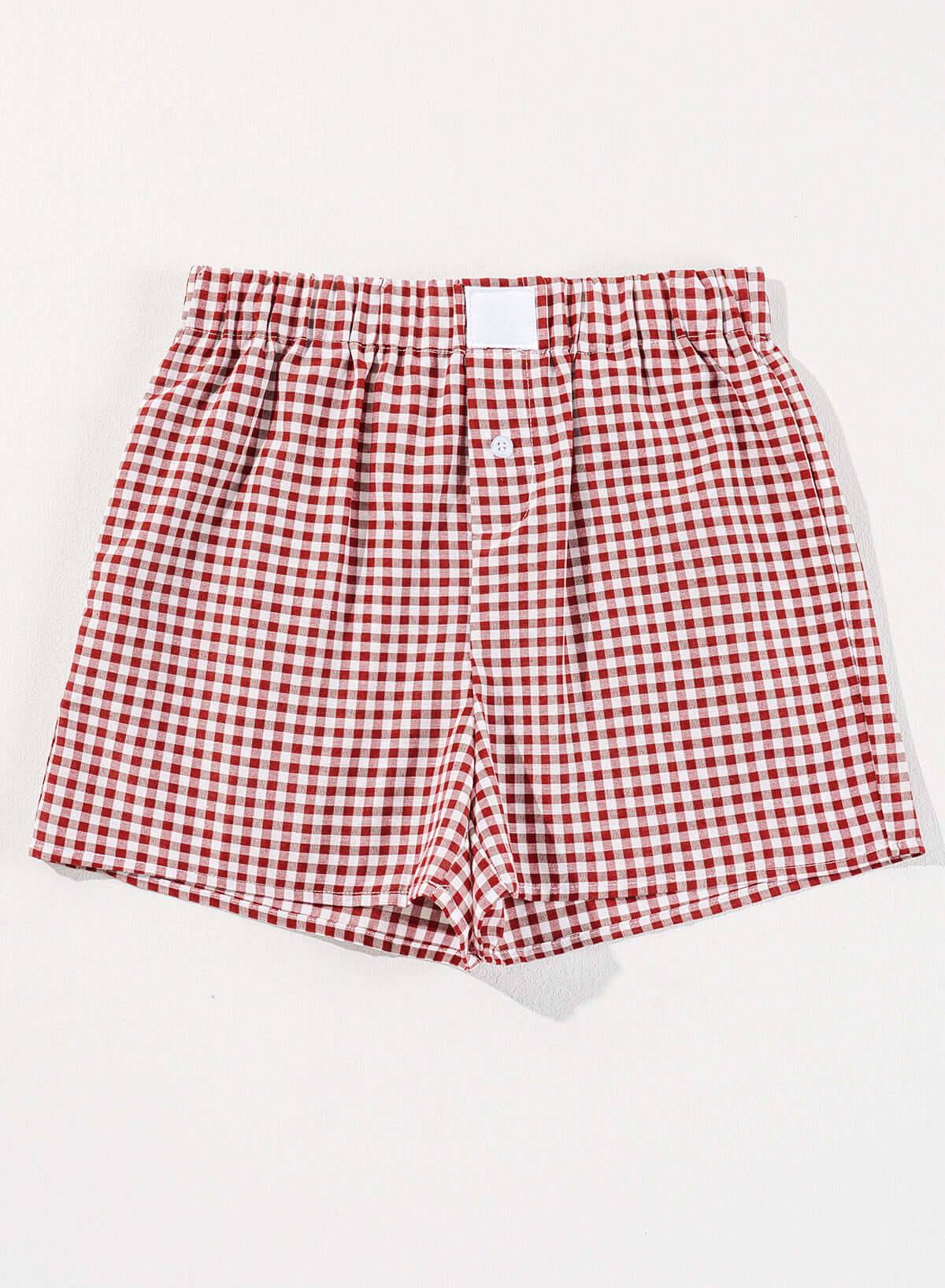Red gingham high waist shorts with elastic waistband and button fly for comfortable summer outings.
