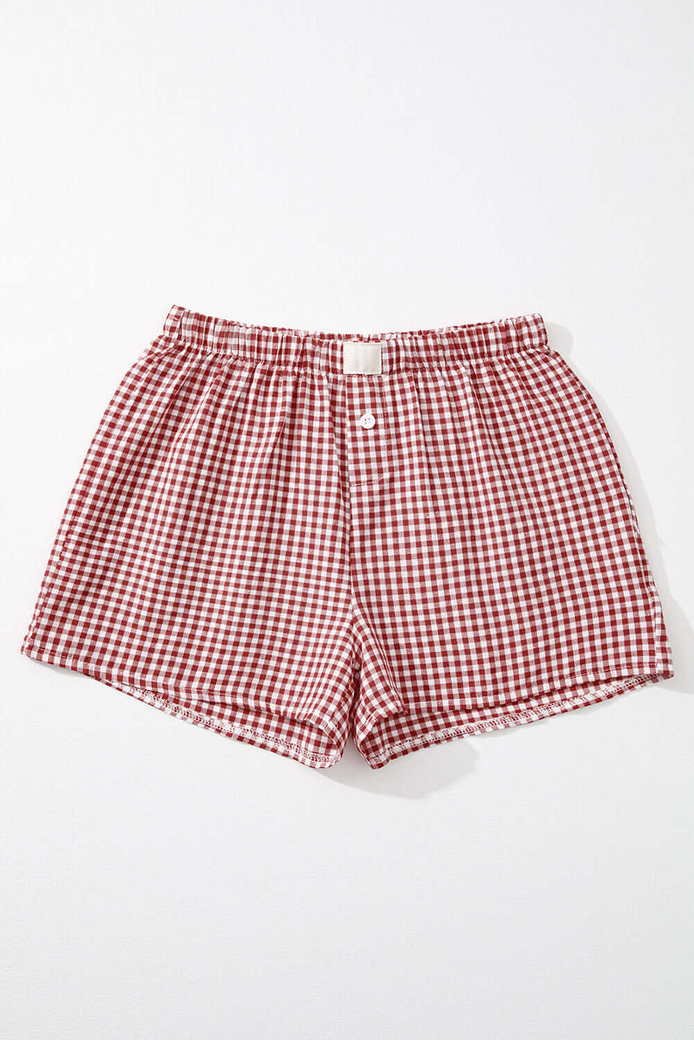 Red gingham high waist shorts with elastic waistband and button fly detail, perfect for sunny picnic days.