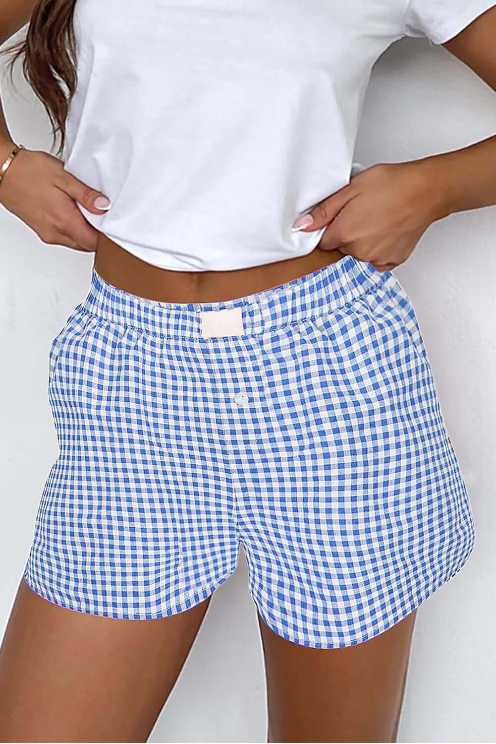 Blue gingham Picnic Perfect Shorts with high waist and elastic waistband, styled for warm-weather wear.