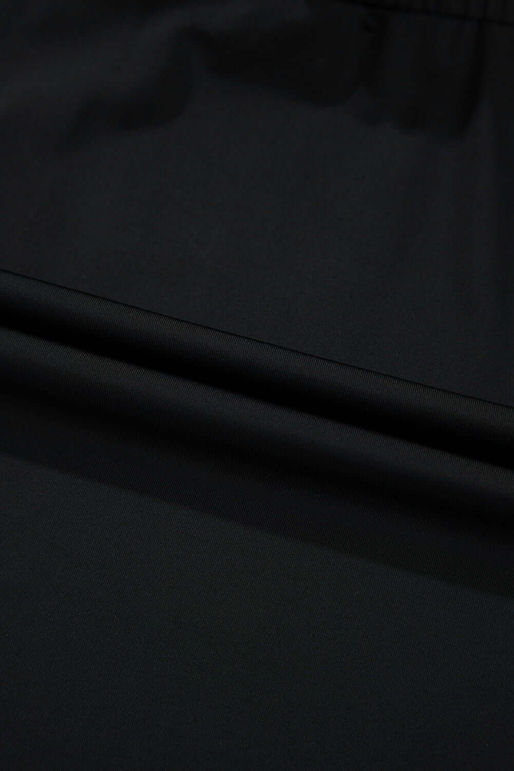 Close-up of the black fabric texture of the TWILIGHT TEMPO SKORT, showcasing its softness and stretch.