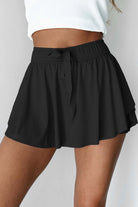 Black Twilight Tempo Skort with a stretchy waistband and flowy overlay for sporty and stylish looks.