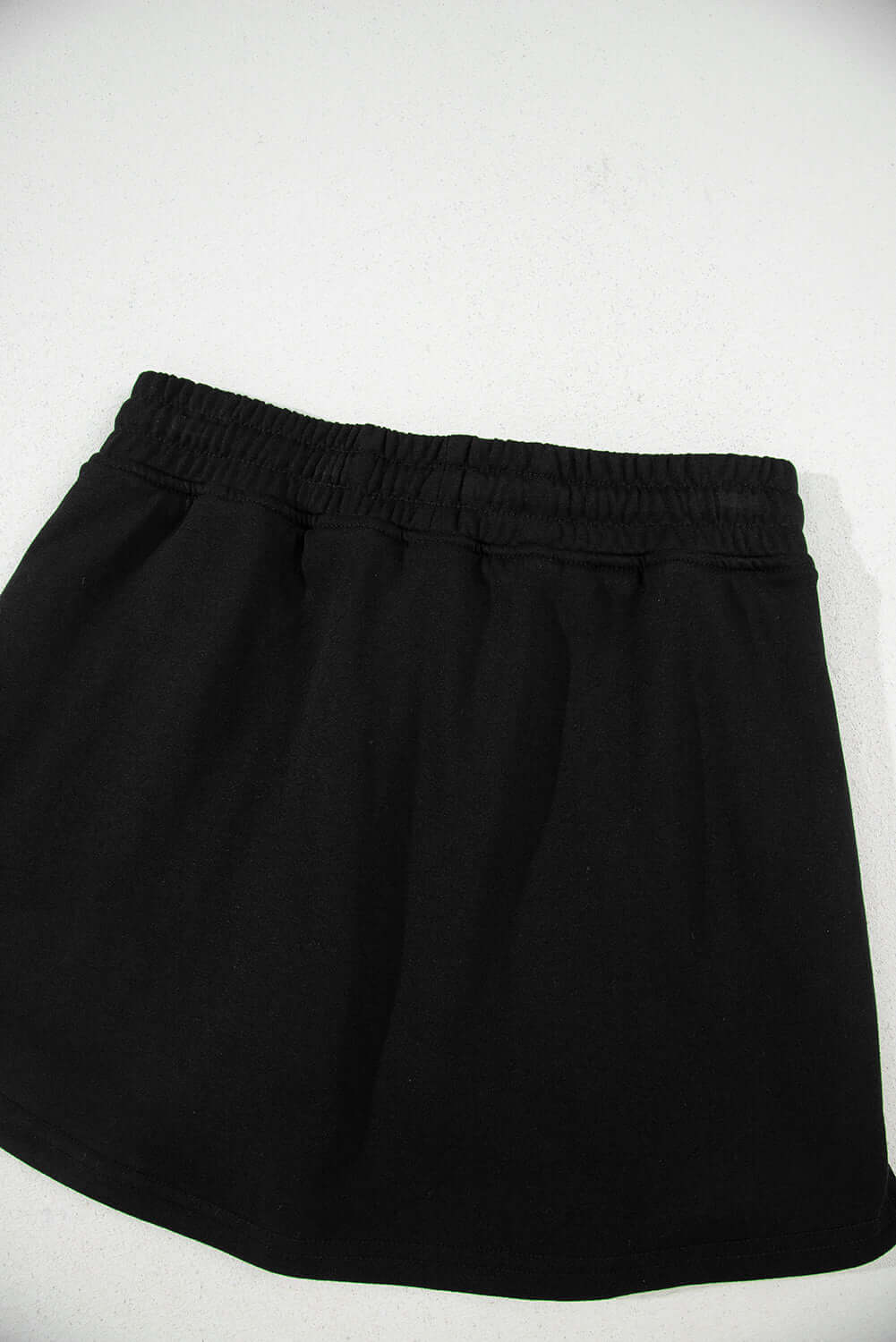 Black French Terry drawstring skort for casual comfort and style, ideal for errands or weekend getaways.
