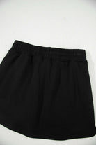 Black French Terry drawstring skort for casual comfort and style, ideal for errands or weekend getaways.