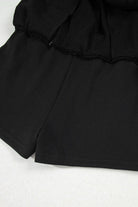 Black French terry skort featuring a drawstring waist and stylish mini skirt design.