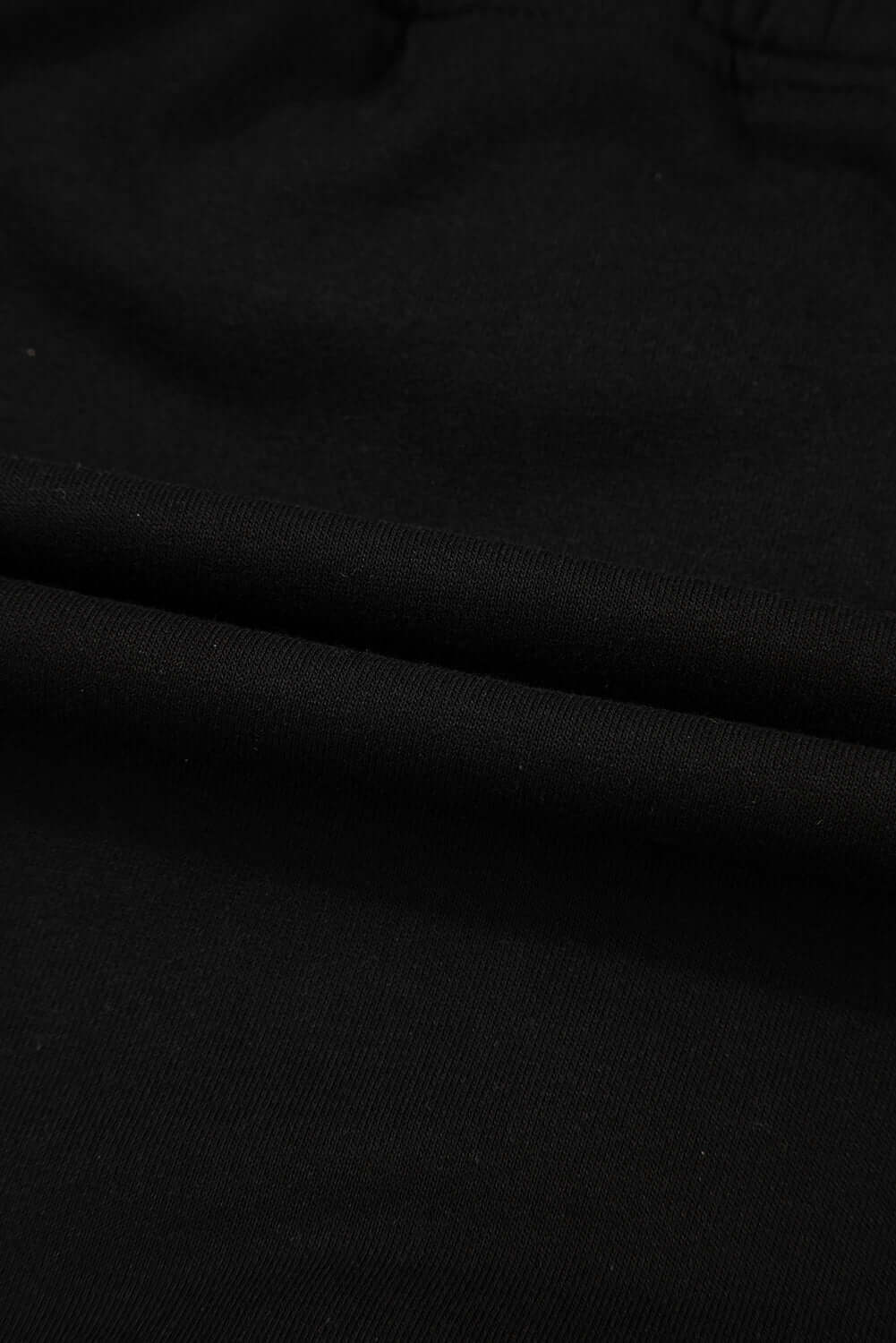 Close-up of soft black French terry fabric for the Skort Story mini skort, showcasing its cozy texture.