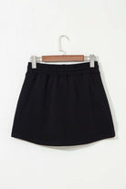 Black French terry drawstring skort, perfect blend of comfort and style for casual wear.