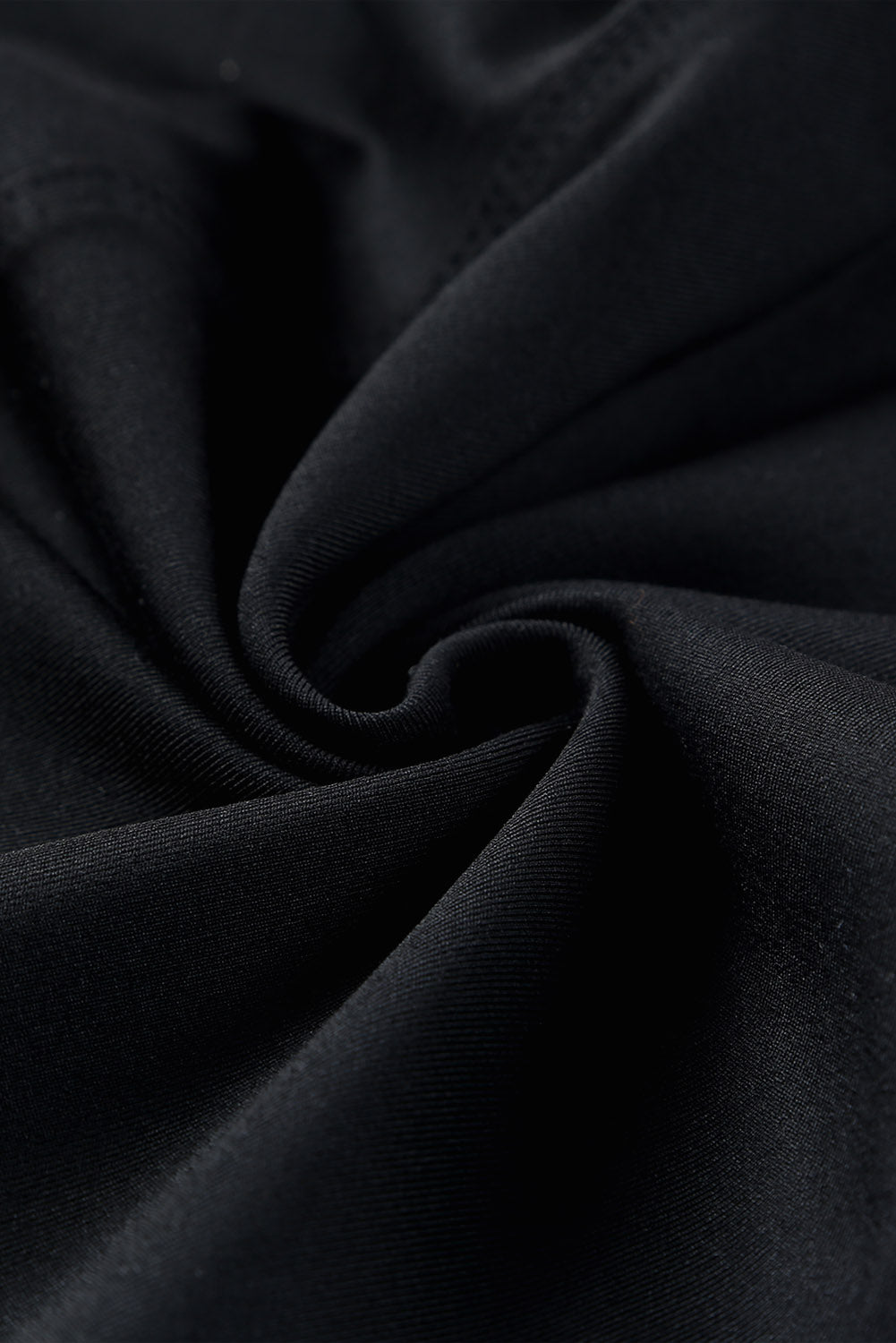 Close-up of soft, stretchy black fabric for Crossed Paths Leggings, showcasing comfort and quality.
