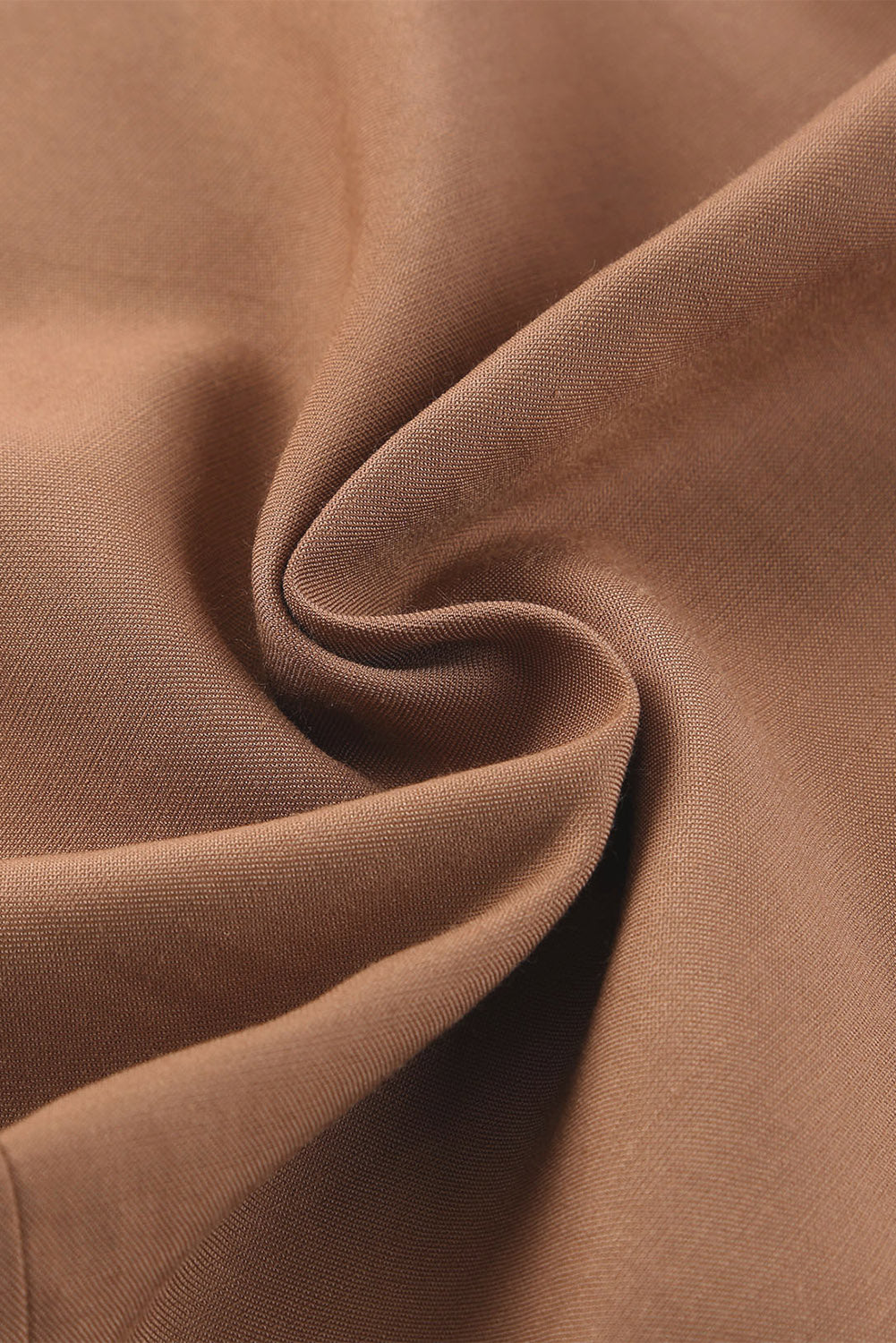 Close-up of caramel latte fabric showcasing the smooth texture and quality material blend of 65% viscose and 35% polyester.