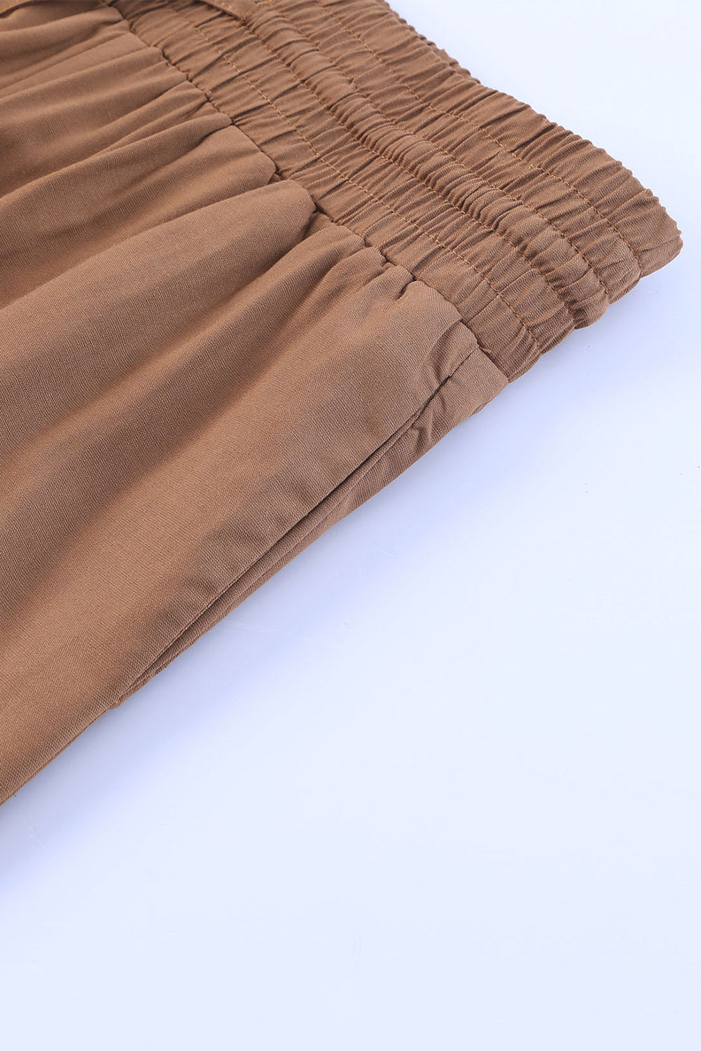 Caramel Latte wide leg pants with smocked waist design and side pockets, showcasing the soft viscose-polyester material.