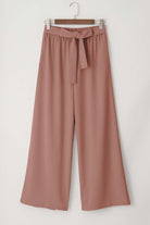 Flowy cocoa wide-leg pants with tie-front sash and side pockets for effortless style.