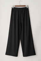CITY SWAY Wide Leg Pants in black, featuring a high-waisted design and relaxed fit, perfect for work-to-weekend style.