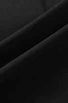 Close-up of soft, textured black fabric ideal for wide leg pants, showcasing its flowy quality for all-day comfort.