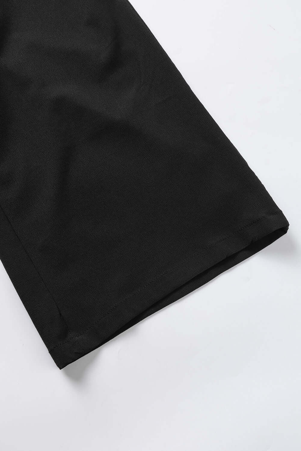 Close-up of the hem of City Sway Wide Leg Pants in black, showcasing soft fabric and relaxed fit.
