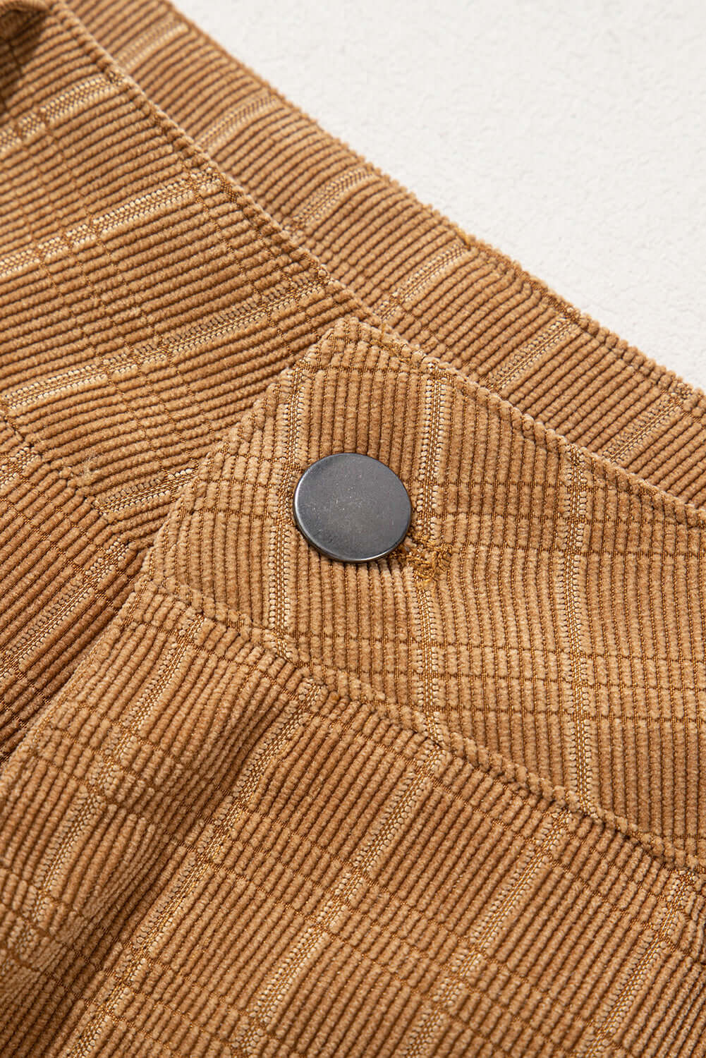 Close-up of checkered corduroy fabric and button detail on MAKING PLANS Pants by Vivian-Lu.