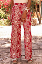 Chic boho glam wide leg pants with red and cream abstract motif, featuring high waist design and elegant button detailing.