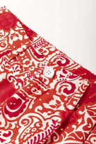 Close-up of Boho Glam wide leg pants featuring red and cream abstract motifs with button detailing.