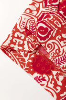 Detail of Boho Glam Wide Leg Pants featuring red and cream abstract motif fabric.