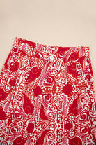 Boho glam wide leg pants with red and cream abstract pattern, featuring button detailing and high waist design.