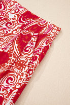 Close-up of Boho Glam Wide Leg Pants in red and cream abstract motif with tailored detailing.