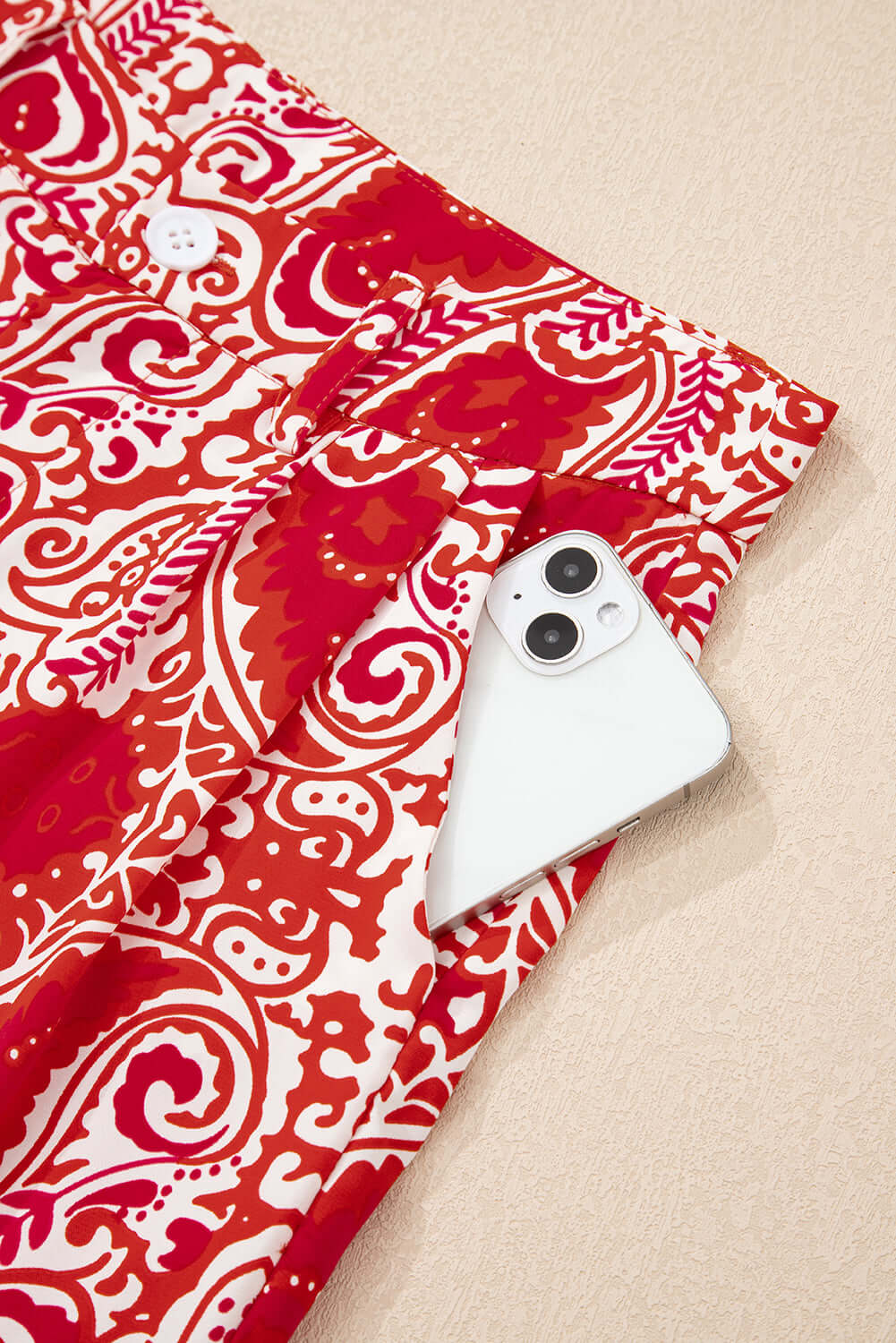 Boho Glam Wide Leg Pants in red and cream with functional pocket holding a smartphone.
