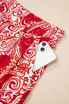 Boho Glam Wide Leg Pants in red and cream with functional pocket holding a smartphone.